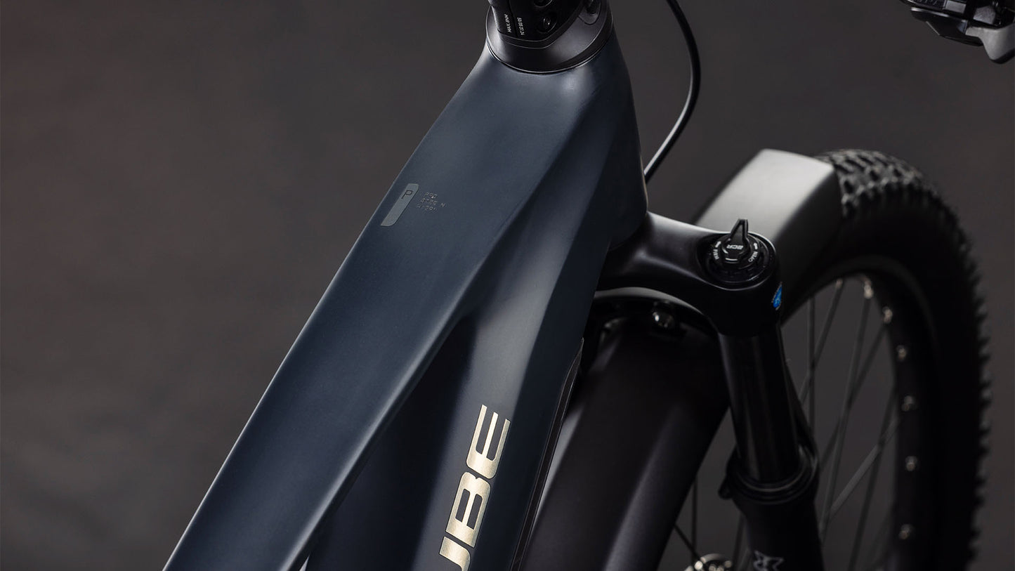 Nahaufnahme des Cube Stereo Hybrid ONE22 Pro 800 FE night'n'chrome 2026 E-Bikes von CUBE. Zu sehen sind das mattschwarze Oberrohr, die Vordergabel, der Bosch CX Motor, ein Teil des Lenkers und der Federung sowie das CUBE Logo auf dunklem Hintergrund.