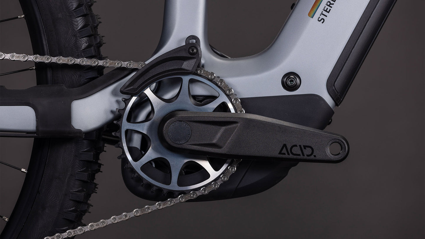 Nahaufnahme einer Fahrradkurbel, eines Kettenblatts und eines Pedalarms am CUBE Stereo Hybrid ONE44 HPC SLX Evo 800 slategrey'n'black 2026 E-MTB, das mit einem Bosch CX-Motor und einem modernen grau-schwarzen Rahmen ausgestattet ist.