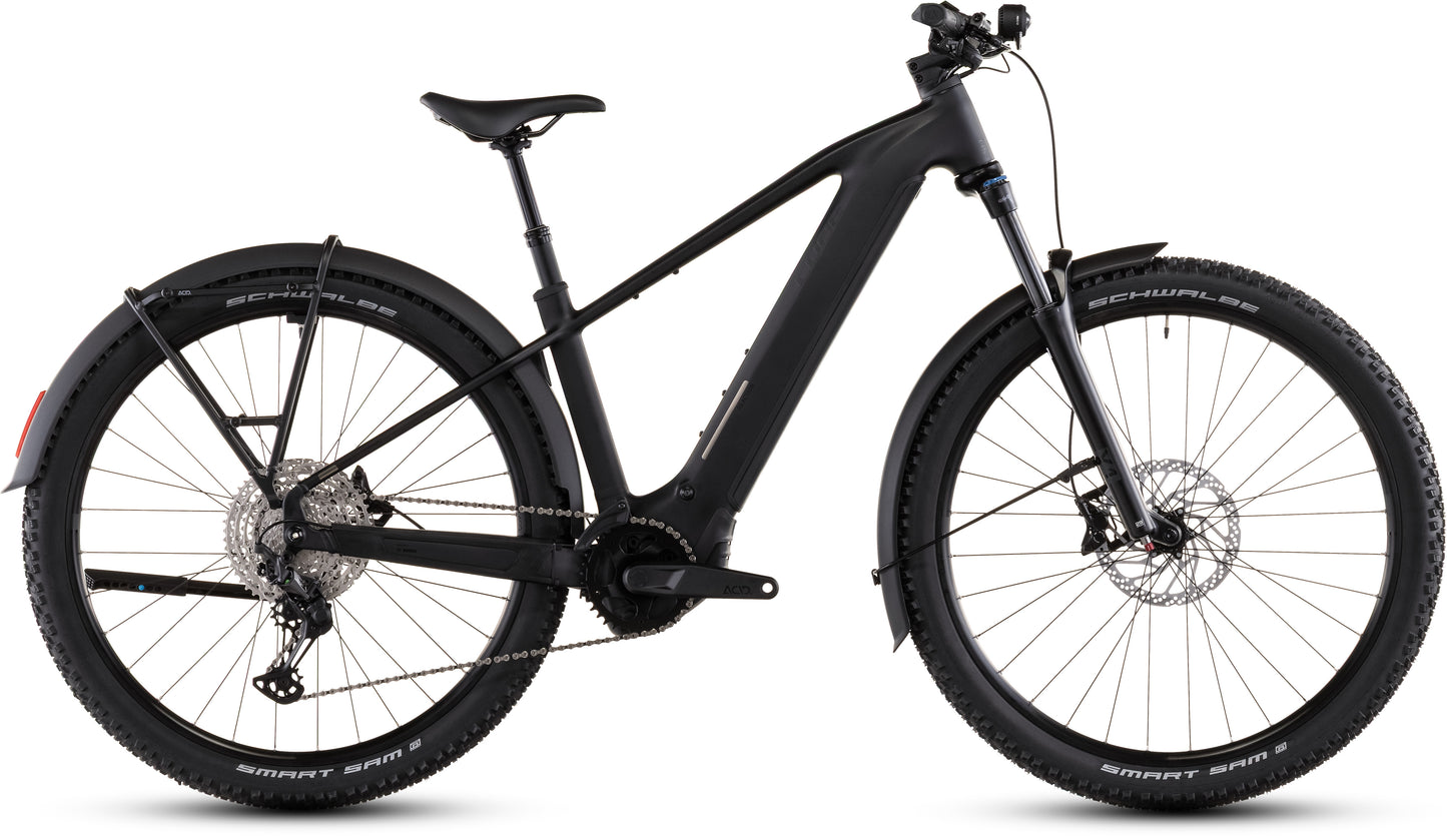 Das CUBE Reaction Hybrid Pro 800 FE blackline 2026 E-Bike hat einen mattschwarzen Rahmen, einen Bosch CX-Motor, Noppenreifen, eine Vorderradaufhängung, Gepäckträgerhalterungen, Schutzbleche und Scheibenbremsen, im Profil auf weißem Hintergrund.