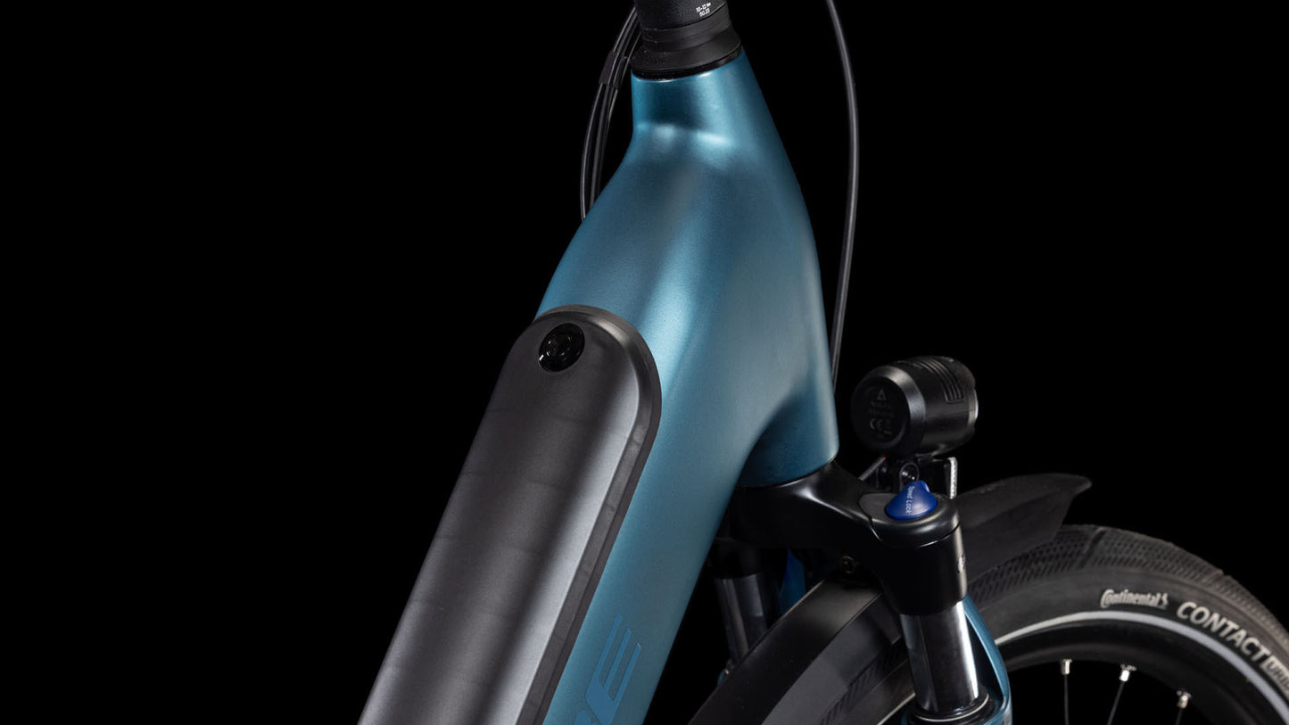 Nahaufnahme des CUBE Supreme RT Hybrid Comfort EXC 625 blue'n'black Easy Entry 2025, die den metallicblauen Rahmen, den Akku, die Federgabel, den Continental-Reifen und den Vorderreifen vor einem schwarzen Hintergrund zeigt.