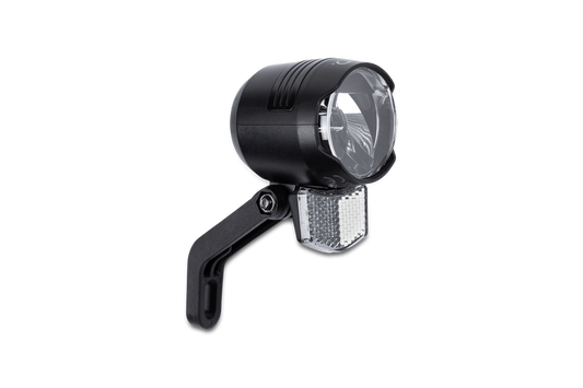 Das ACID E-Bike Frontlicht PRO-E 60 CMPT X-Connect schwarz, mit klarer Scheibe, schwarzer Halterung und kleinem weißen Reflektor darunter, ist im CUBE Store in Hildesheim, Niedersachsen, erhältlich.