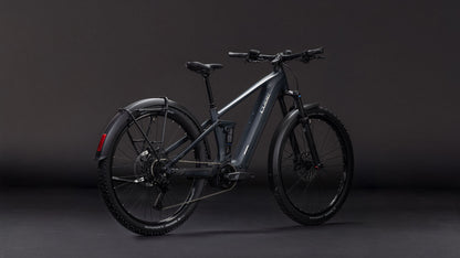 Das CUBE Stereo Hybrid ONE22 Pro 800 FE night'n'chrome 2026 verfügt über einen mattgrauen Rahmen, einen Bosch CX-Motor, eine Vorderradaufhängung, dicke Reifen, Scheibenbremsen und ein hinteres Schutzblech - und das alles vor einem dunklen Hintergrund.