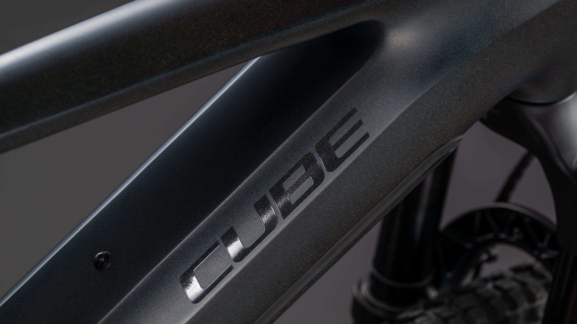 Nahaufnahme des CUBE Stereo Hybrid ONE22 SLT 800 prizmblack'n'black 2026 Rahmens in mattschwarz, mit auffälligem "CUBE"-Schriftzug, glattem, kantigem Design und leistungsstarkem Bosch CX Antrieb für beste E-Mountainbike-Performance.