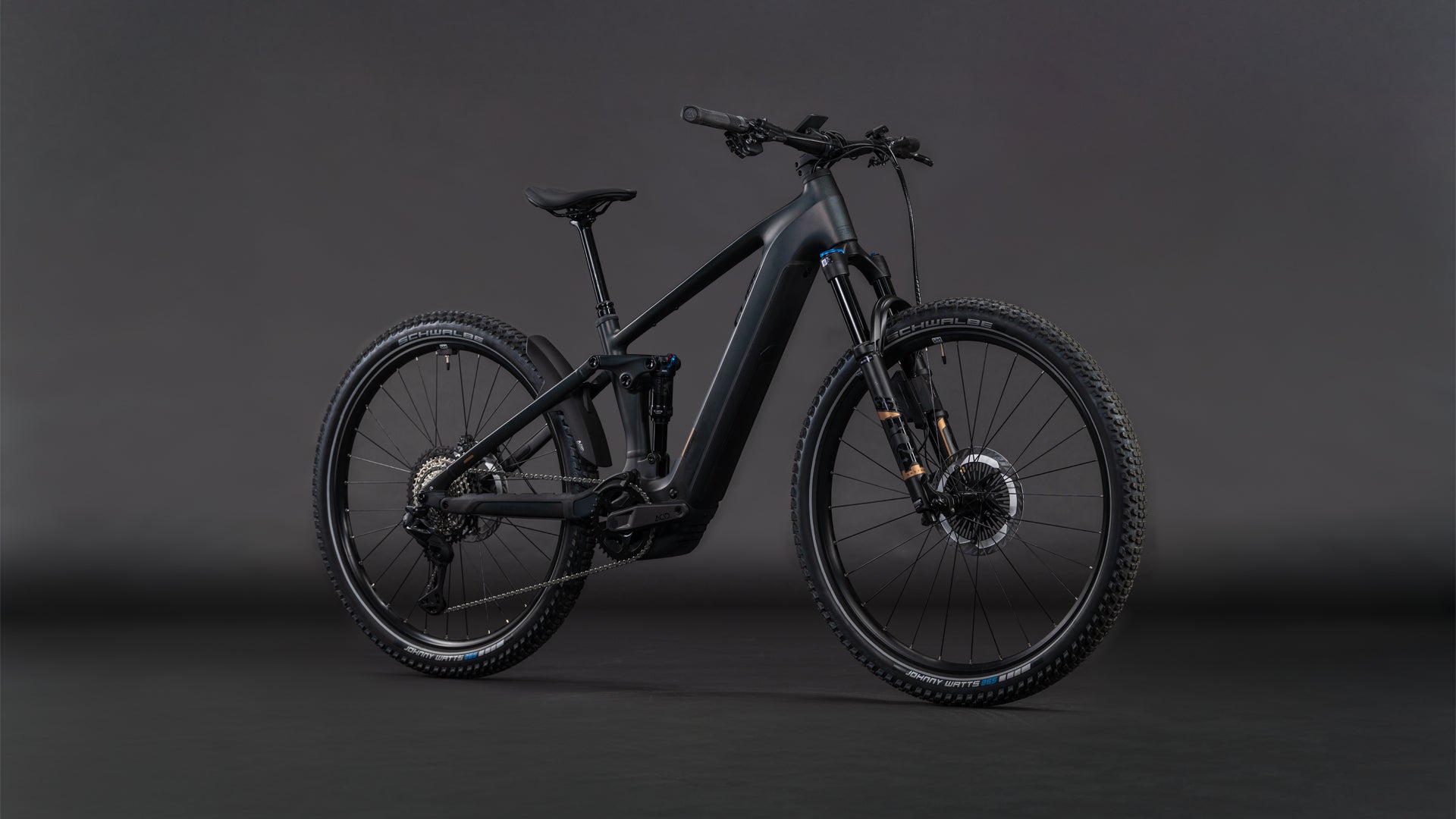 Das CUBE Stereo Hybrid ONE22 SLT 800 prizmblack'n'black 2026, ein schnittiges schwarzes E-Mountainbike mit dicken Reifen, Vollfederung, Bosch CX Antrieb, Shimano XT Di2 Teilen und Scheibenbremsen, steht vor einem dunklen, nahtlosen Hintergrund.