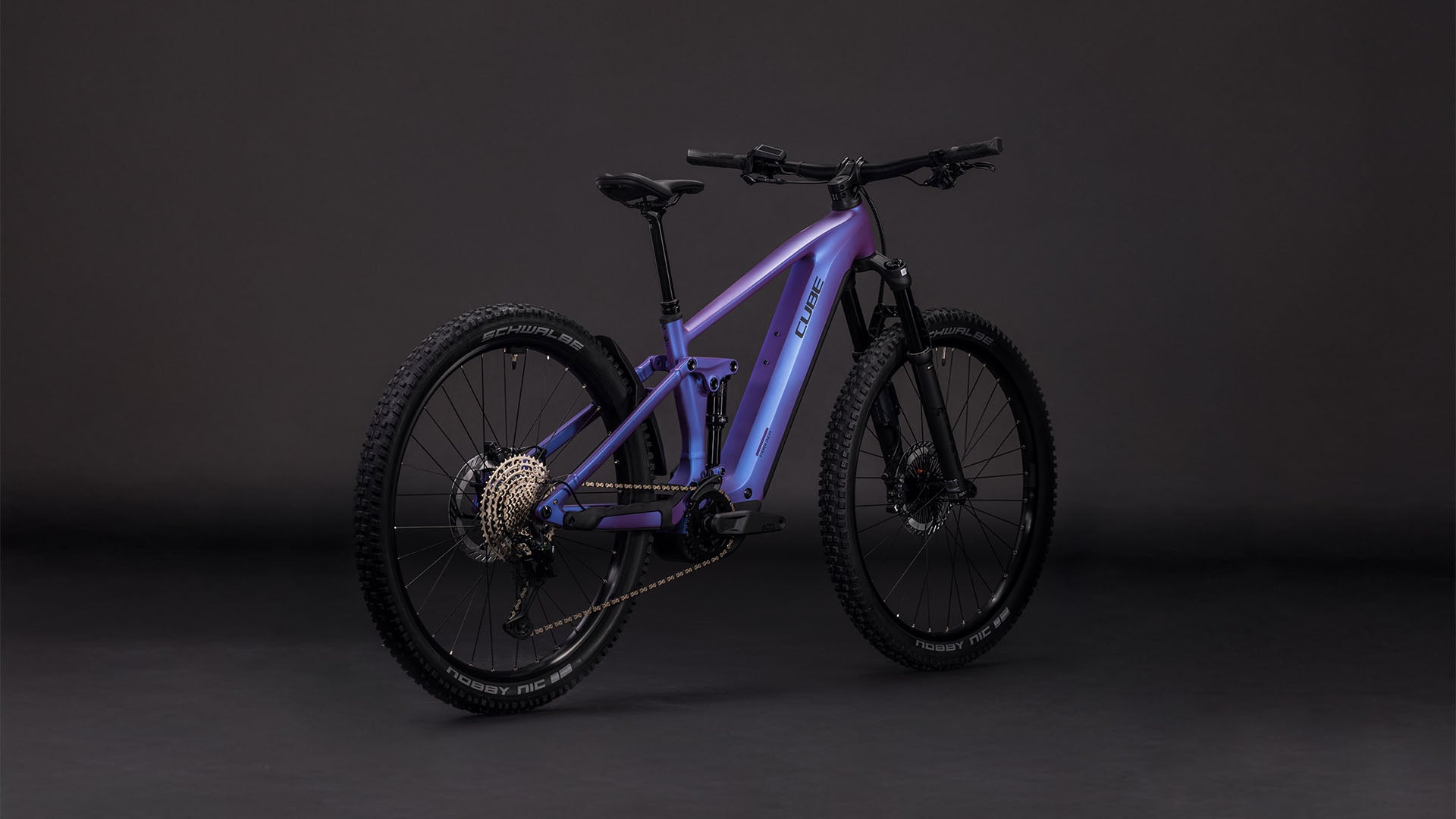 Das CUBE Stereo Hybrid ONE44 EXC 800 blueiris'n'black 2026 Elektro-Mountainbike mit robustem Rahmen, dicken Reifen, Bosch CX-Motor und zentralem Akku wird vor einem dunklen, nahtlosen Hintergrund gezeigt.