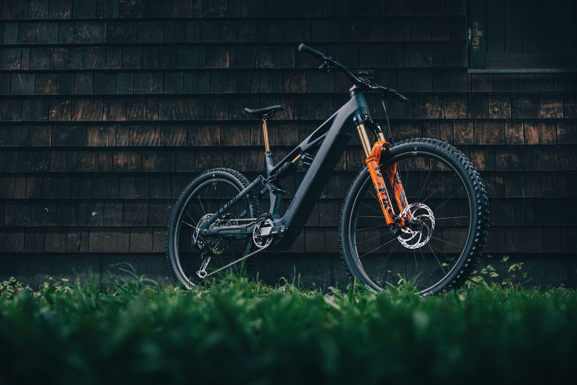 Das Stereo Hybrid one77 vor einem Haus 