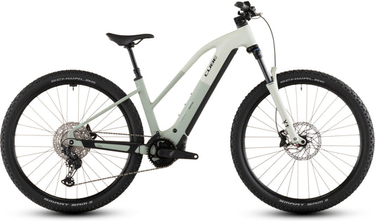 Das CUBE Reaction Hybrid Pro 800 desertstone'n'driedherbs Trapeze 2026 ist ein modernes E-Mountainbike mit hellgrauem Rahmen, Bosch CX-Antrieb, Federgabel, schwarzem Sattel, Schwalbe-Reifen und Scheibenbremsen, abgebildet seitlich auf Weiß.