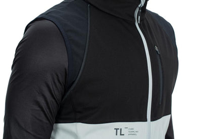 Nahaufnahme einer Person, die die CUBE TEAMLINE Multifunktionsjacke black'n'grey trägt. Sie hat abnehmbare Ärmel, eine Brusttasche mit Reißverschluss, wind- und wasserabweisendes Material und das CUBE Logo auf der Vorderseite.